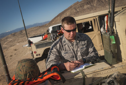 Capt. Bradley Siefert, 69th Bomb Squadron pilot, takes notes during Integrated Training Exercise 2-15 on Marine Corps Air Ground Combat Center Twentynine Palms, Calif., Feb. 12, 2015. Aircrews from the 69th BS provided close-air support to Marine ground units during the exercise. (U.S. Air Force photo/Airman 1st Class Apryl Hall)