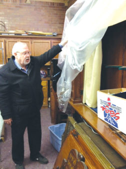 Dr. Dennis Lutz shows where remnants of the synagogue are stored in a railroad museum storeroom. Photo by Roy Cammarillo, courtesy of Jweekly.com