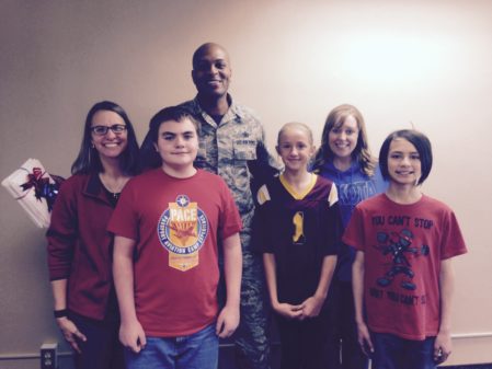 Kathryn Lenertz, Dakota Elementary School principal, Col. Roy Collins, 5th Mission Support Group commander, and Jade Feller, Dakota Elementary School counselor, take a photo with participants of the random acts of kindness event, James Townsend, Taylor Link and Benito Isla at Minot Air Force Base, N.D., June 2, 2015. At the beginning of May, the students learned about what RAOKs are and how they can make a difference. (Courtesy photo)
