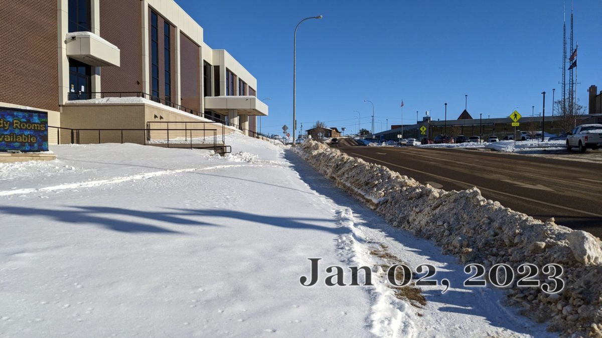 The sidewalk in front of Minot Public Library. One of the few places where there is evidence of City sidewalk maintenance. 